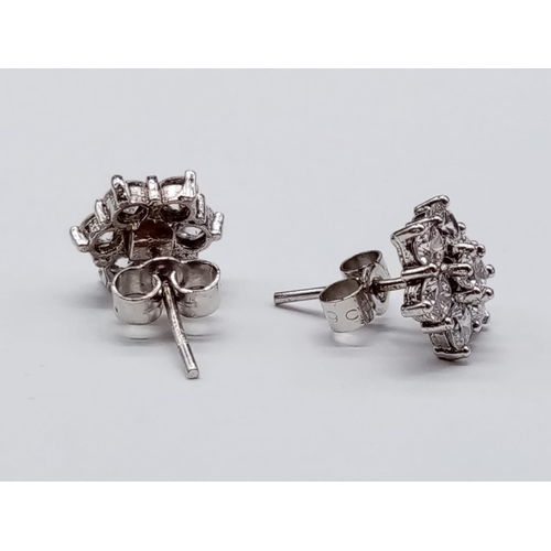 854 - Pair of 9ct White Gold and CZ stones EARRINGS in a floral design.  2.5g    1cm width.