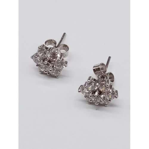 854 - Pair of 9ct White Gold and CZ stones EARRINGS in a floral design.  2.5g    1cm width.