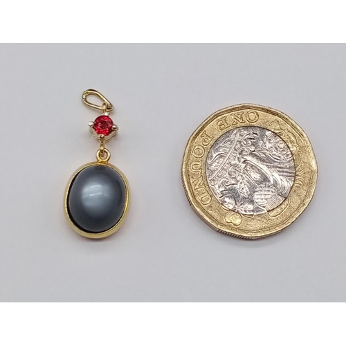 884 - Yellow Metal Ruby and Moonstone PENDANT.  3.37g  2cm drop