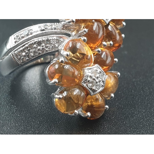109 - A MODERN DESIGN CROSS OVER RING IN 18CT WHITE GOLD WITH DIAMONDS AND QUALITY CITRINE .
10.8gms    SI... 