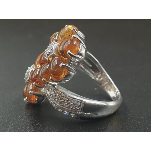 109 - A MODERN DESIGN CROSS OVER RING IN 18CT WHITE GOLD WITH DIAMONDS AND QUALITY CITRINE .
10.8gms    SI... 
