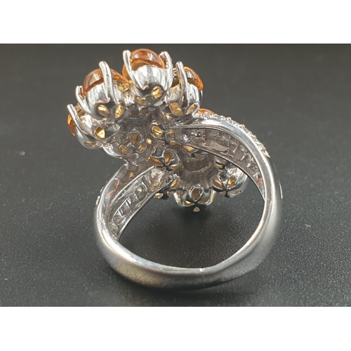 109 - A MODERN DESIGN CROSS OVER RING IN 18CT WHITE GOLD WITH DIAMONDS AND QUALITY CITRINE .
10.8gms    SI... 