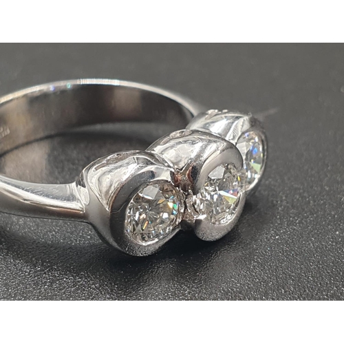 129 - AN 18CT WHITE GOLD RING WITH A TRILOGY OF DIAMONDS OF OVER 1CT. 6.7gms SIZE O