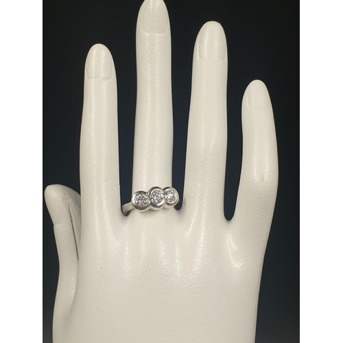 129 - AN 18CT WHITE GOLD RING WITH A TRILOGY OF DIAMONDS OF OVER 1CT. 6.7gms SIZE O