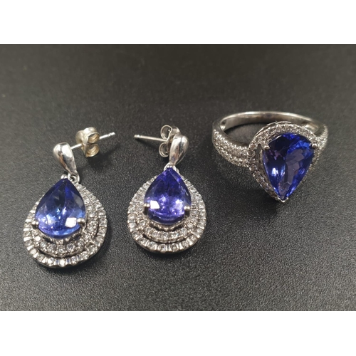 133 - A 14CT WHITE GOLD MATCHING SET OF EARRINGS AND DRESS RING WITH LARGE PEAR SHAPED TANZANITE STONES AN... 