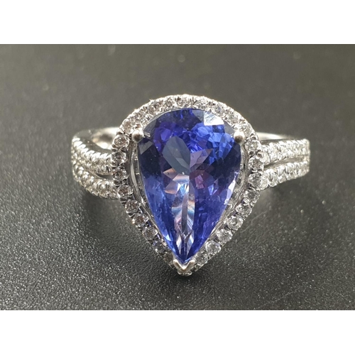 133 - A 14CT WHITE GOLD MATCHING SET OF EARRINGS AND DRESS RING WITH LARGE PEAR SHAPED TANZANITE STONES AN... 