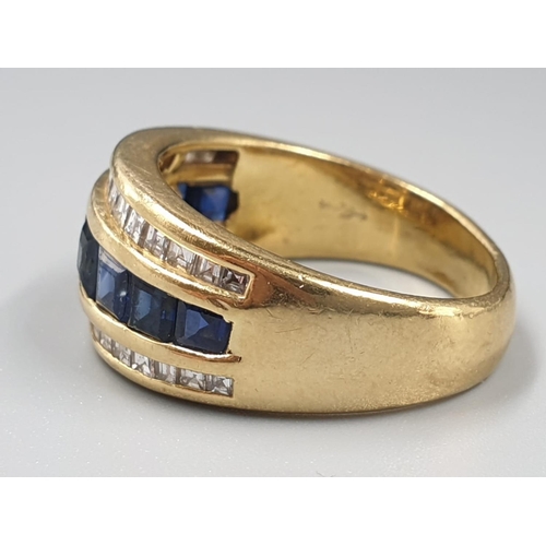 140 - AN 18CT GOLD RING WITH CHANNEL SET DIAMONDS AND SAPHIRES 7.4gms SIZE N