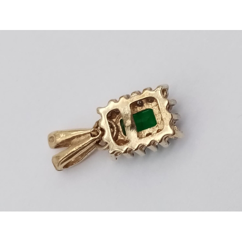 186 - Emerald and diamond pendant in yellow gold setting