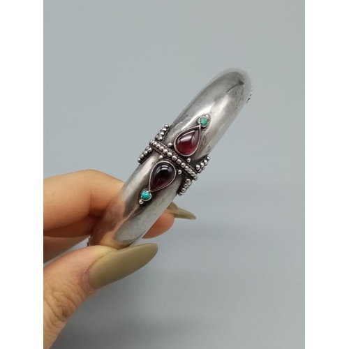 213 - Jewish Silver bangle with garnet and turquoise, weight 49g and 6cm diameter inner width