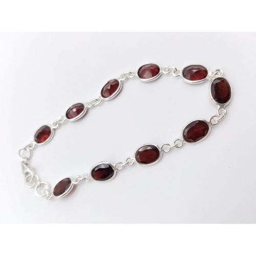 264 - A ruby chain bracelet, Garnet bracelet and three stone ring SIZE O in 925 silver