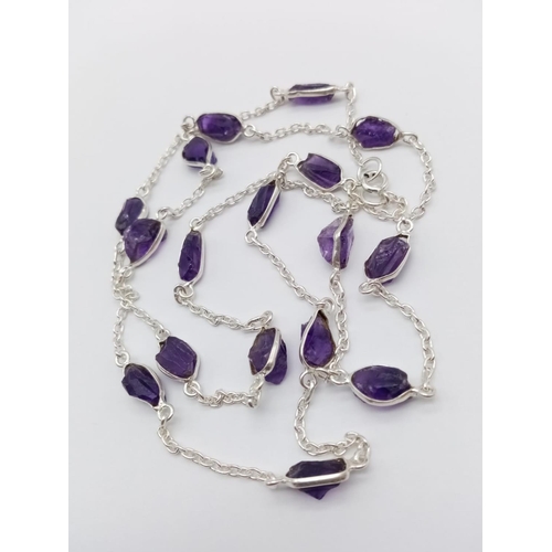 433 - A raw amethyst gemstone necklace with matching dangler earrings in 925 silver