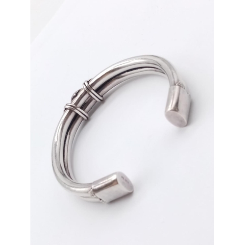 504 - Opal silver bangle, weight 28g and 6.5cm width