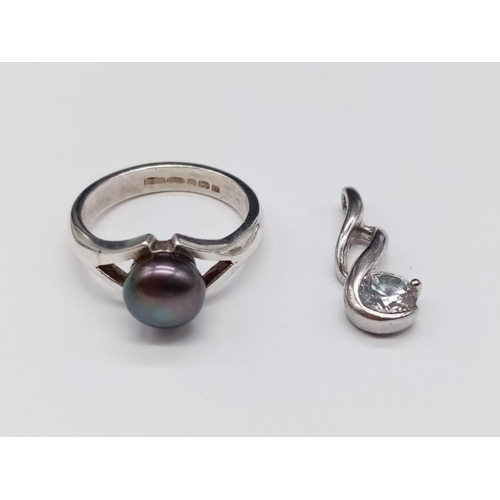 875 - A miniature Silver Pendant(2cm) and Ring, Size N. 5.22g total weight.