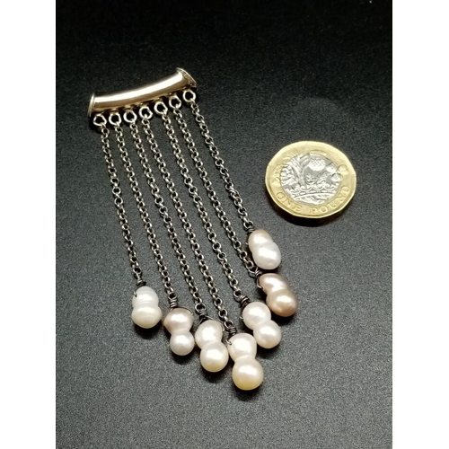 919 - A Silver and Pearl Drop Pendant. 8cm drop. 11.5g