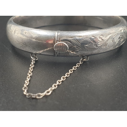 217 - A VINTAGE SILVER BANGLE WITH HINGE AND SAFETY CHAIN IN ORIGINAL BOX  16.1gms