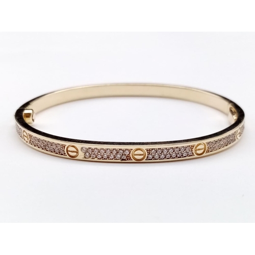 23 - 9CT YELLOW GOLD CZ SET BANGLE CARTIER STYLE, WEIGHT 14.6G