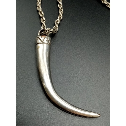 643 - White metal claw pendant on chain, weight 43g chain 72cm long and pendant 7cm drop approx