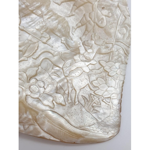 91 - An Antique Chinese Mother Of Pearl Shell. Deep Carved with a Warrior Scene. 17 x 20cm