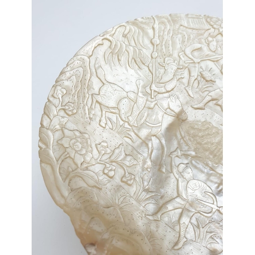 91 - An Antique Chinese Mother Of Pearl Shell. Deep Carved with a Warrior Scene. 17 x 20cm