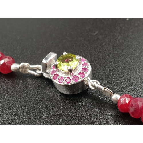 175 - A 220cts single row Africa ruby necklace with a sterling silver ruby and peridot gemstone clasp 47cm