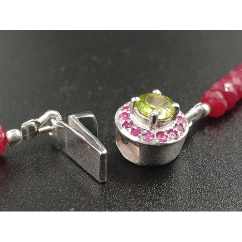 175 - A 220cts single row Africa ruby necklace with a sterling silver ruby and peridot gemstone clasp 47cm