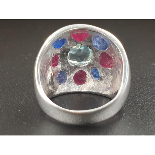 378 - A Cocktail ring with natural rubies and Blue sapphires and a flat blue moissanite in the center. Siz... 