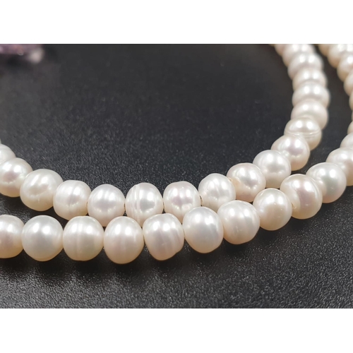 392 - A 4mm freshwater pearl necklace with Amethyst drops , sterling silver clasp