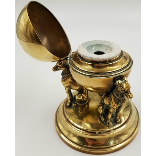 92 - A VICTORIAN BRASS INKWELL IN THE FORM OF 3 DOGS SUPPORTING A GLOBE. WEIGHING JUST OVER 500gms AND ST... 