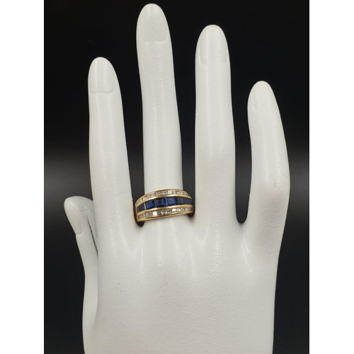 543 - AN 18CT GOLD RING WITH CHANNEL SET DIAMONDS AND SAPHIRES 7.4gms SIZE N