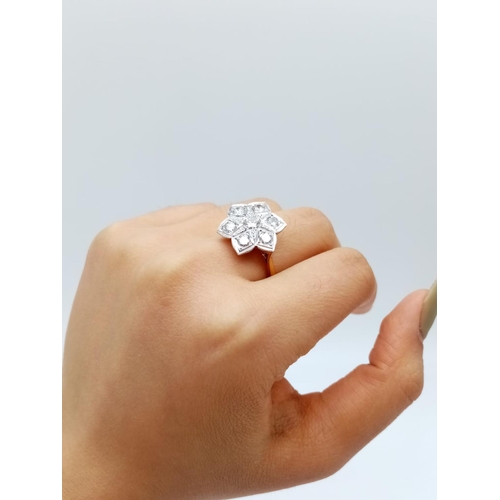 571 - AN 18ct GOLD RING WITH 1.08CT OF BRILLIANT DIAMONDS FORMING A PRETTY FLORAL EFFECT.
6.00gms   SIZE O