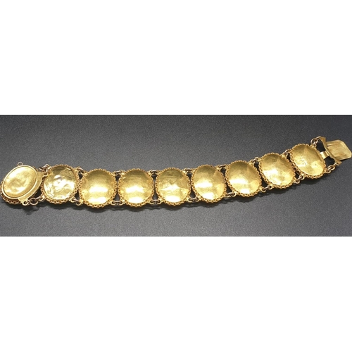 262 - AN INDIAN 19TH CENTURY 22CT GOLD PORTRAIT BRACELET. 43 1gms  and 19cms long.