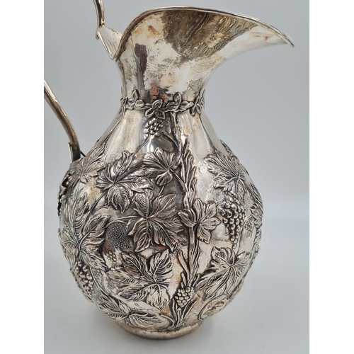 178 - A LARGE SPANISH SILVER WATER JUG HAND FASHIONED CIRCA 1920. 474.4 gms and 27cms TALL