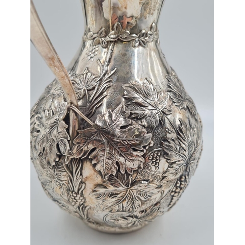 178 - A LARGE SPANISH SILVER WATER JUG HAND FASHIONED CIRCA 1920. 474.4 gms and 27cms TALL