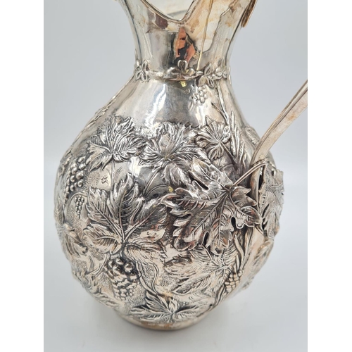 178 - A LARGE SPANISH SILVER WATER JUG HAND FASHIONED CIRCA 1920. 474.4 gms and 27cms TALL