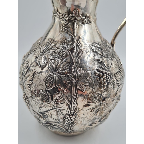 178 - A LARGE SPANISH SILVER WATER JUG HAND FASHIONED CIRCA 1920. 474.4 gms and 27cms TALL