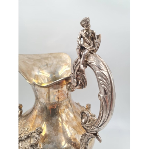 157 - A LARGE SPANISH SILVER ETRUSCAN SHAPED WATER JUG, HAND DECORATED WITH CHERUBS AND FLORA.
1.2kg and 3... 