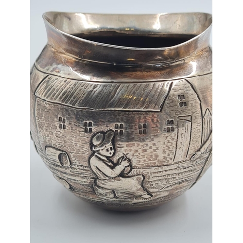 131 - 19TH CENTURY GERMAN SILVER BOWL PORTRAYING VILLAGE LIFE. 75.7gms AND 7.5cms IN HEIGHT