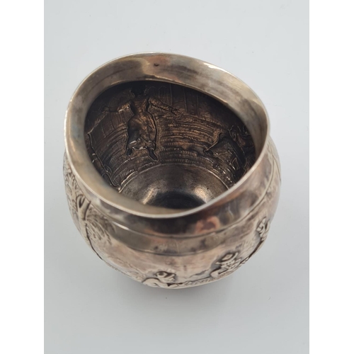 131 - 19TH CENTURY GERMAN SILVER BOWL PORTRAYING VILLAGE LIFE. 75.7gms AND 7.5cms IN HEIGHT