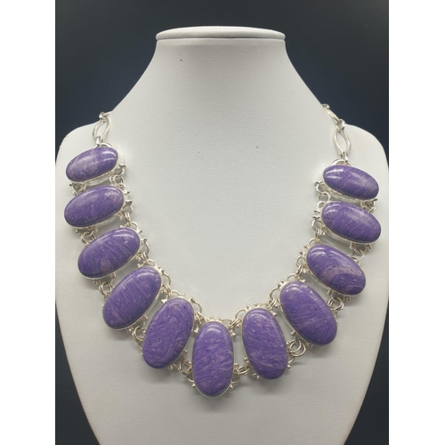 759 - A rare and beautiful white metal (untested) Russian charoite necklace and earrings set in a presenta... 