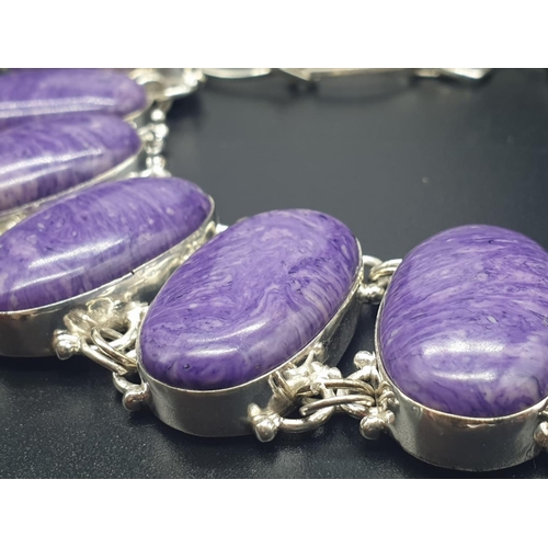 759 - A rare and beautiful white metal (untested) Russian charoite necklace and earrings set in a presenta... 