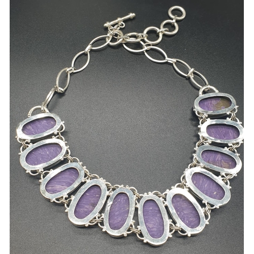 759 - A rare and beautiful white metal (untested) Russian charoite necklace and earrings set in a presenta... 