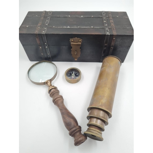 765 - An antique explorer’s basic kit including a compass, a 4 draw telescope and a magnifying glass, in a... 