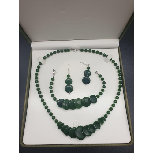 797 - A modern spinach green jade necklace, bracelet and earrings set in a presentation box. Necklace leng... 