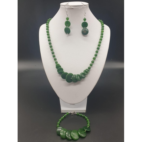 797 - A modern spinach green jade necklace, bracelet and earrings set in a presentation box. Necklace leng... 