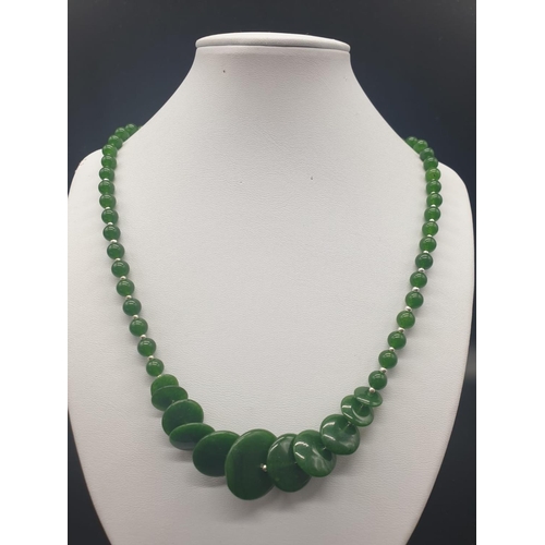 797 - A modern spinach green jade necklace, bracelet and earrings set in a presentation box. Necklace leng... 