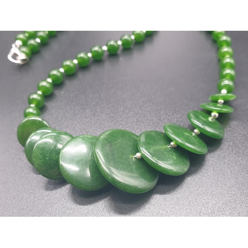 797 - A modern spinach green jade necklace, bracelet and earrings set in a presentation box. Necklace leng... 