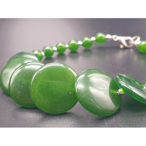 797 - A modern spinach green jade necklace, bracelet and earrings set in a presentation box. Necklace leng... 