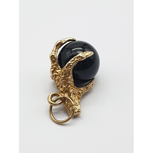 195 - 9K Gold Eagle Claw Charm, holding Black Onyx Ball.
4.91g total weight.