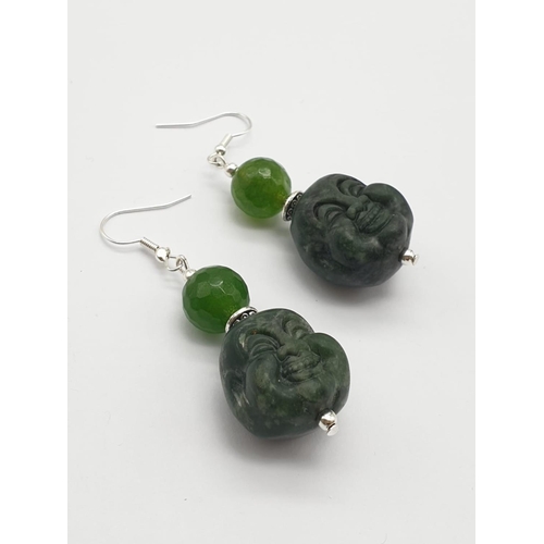 250 - A Tibetan silver and green jade necklace and earrings set with hand carved smiling Buddha head penda... 