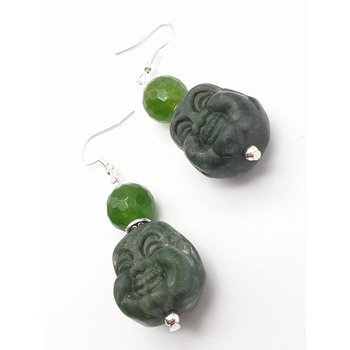 250 - A Tibetan silver and green jade necklace and earrings set with hand carved smiling Buddha head penda... 